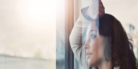 a professional woman looking out of the window
